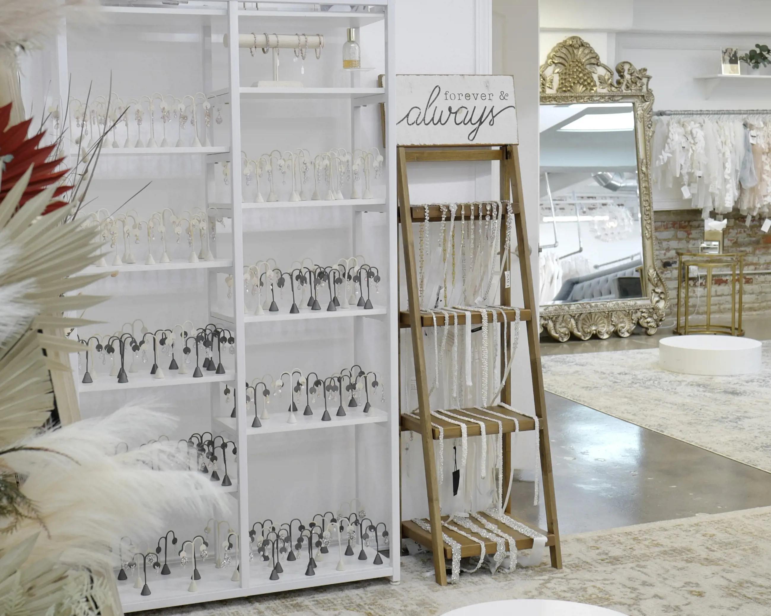 Display of accessories such as belts, earrings, and necklaces at Liliana Bridal House