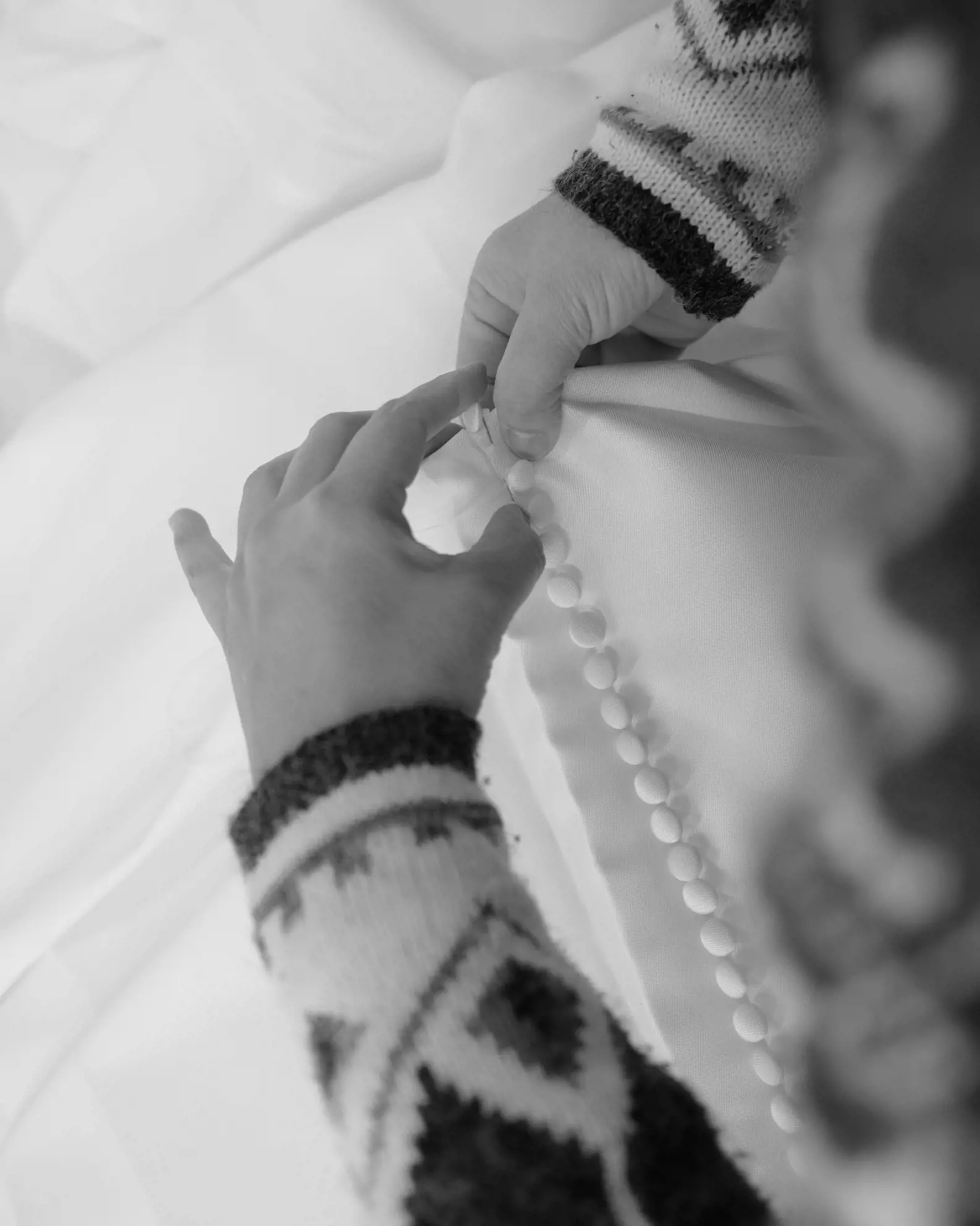 Seamstress working on wedding dress alterations